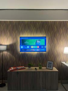 a tv on a wall in a living room at Cozy Spacious 2BR Unit in Davao City