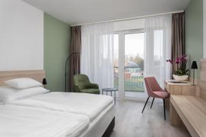 Postel nebo postele na pokoji v ubytování Hunguest Hotel Flóra