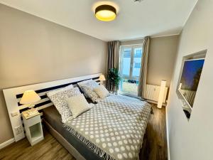 Postel nebo postele na pokoji v ubytování Ferienwohnung Nr 124 Sehnsucht-Zingst