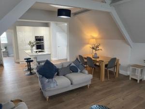 a living room with a couch and a table at Ideal Contractor Business & Family Friendly 2-Bed Apartment Quiet & Spotless with Fast WiFi Large Screen Smart TV in Wakefield