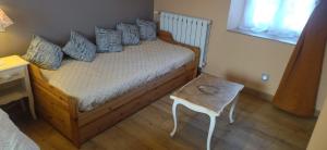 a bedroom with a bed with blue pillows and a table at La Cigaliere in Bézenet