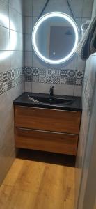 a bathroom with a black sink and a mirror at La Cigaliere in Bézenet +23 photos