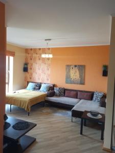 a living room with a bed and a couch at SolarisStudioApartments near the Airport in Riga +57 photos