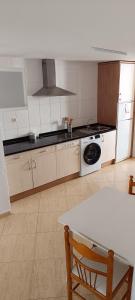 a kitchen with a sink and a stove top oven at Marcotin Piscina playa y montaña in Alcossebre