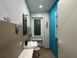 un bagno con un lavandino bianco e un water di Viamare Anzio ad Anzio