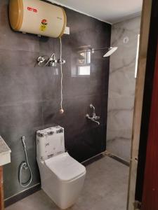a bathroom with a toilet and a shower at Shri Rudra's Quad Bed Rooms in Bhowāli