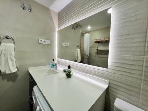 a bathroom with a white sink and a mirror at Alta Vista! in Puerto de Mazarrón +8 photos