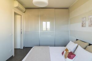 a bedroom with a bed and a glass wall at Charme Relax e Terrazza a Vista in Sirmione +35 photos