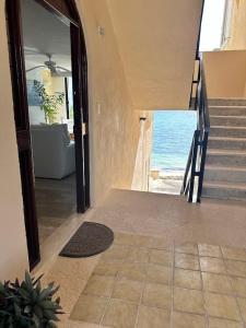 a hallway of a house with a view of the ocean at A la Orilla del mar Puerto Juarez Cancun in Cancún +46 photos