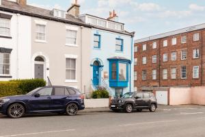 two cars parked in front of a building at The Town House in Whitby