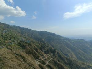 an aerial view of a mountain with a road on it at The village lodge Dalhousie in Banikhet