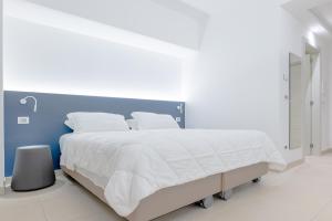 Postel nebo postele na pokoji v ubytování LHI Healthy Hotel Lecce