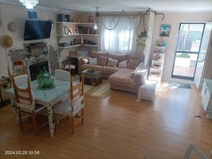a living room with a table and a couch at CasaElaqui in Atarfe
