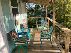 a group of chairs sitting on a porch at Green garden view in New Orleans