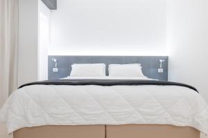 Postel nebo postele na pokoji v ubytování LHI Healthy Hotel Lecce