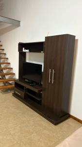 a entertainment center with a flat screen tv in a room at Duplex 2 Villa Ramallo in Estación Ramallo +13 photos