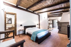 a large bedroom with a bed and a fireplace at Tenuta Torre di Pian Castagno in Sutri +34 photos
