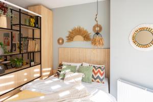 a bedroom with a bed and a book shelf at Boho apartment studio in Batumi +59 photos