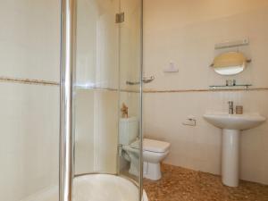 a bathroom with a shower and a toilet and a sink at 2 Bell Tower in Penzance +20 photos