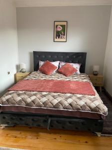 a bedroom with a large bed with two pillows at Viola 144 in Han Pijesak