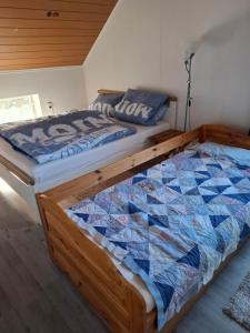 a bedroom with a wooden bed with a quilt on it at Apartment Lulu in Aurich