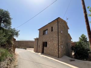 an old brick building on the side of a road at Cal Gabarró - Casa para 12 con piscina, WiFi, AC y BBQ in Vilanova de Meyá