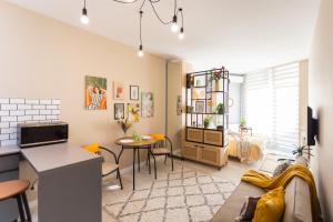 a living room with a couch and a table at Boho apartment studio in Batumi