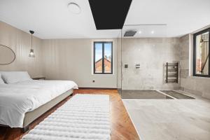 a bedroom with a large bed and a shower at Maison d'architecte avec Jacuzzi, Quartier Prémontrés in Pont-à-Mousson