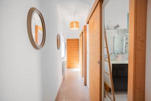 un pasillo que conduce a una cocina con espejo en Casa Olâ House, en Luri 26 fotos más
