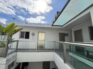 a balcony of a house with glass railing at Condohotel Mictlan Akumal in Akumal