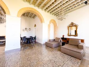 a living room with two couches and a table at Casa Plaza Candelaria Cádiz Grupo AC Gestión in Cádiz