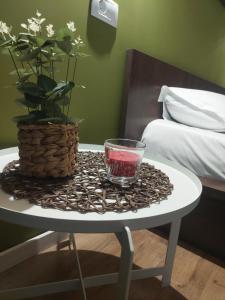 a table with a glass on it with a plant on it at Best City View in Craiova