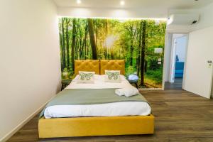 a bedroom with a large bed with a forest backdrop at Villa Le Chianche in Vico del Gargano