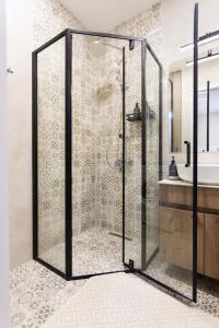 a shower with a glass door in a bathroom at Boho apartment studio in Batumi +57 photos