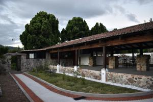 a stone building with a table and chairs in it at Suite de lujo en finca de café in Antigua Guatemala