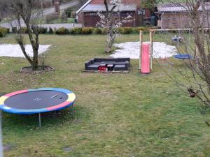 an empty playground with a trampoline and a playground at Apartment Lulu in Aurich