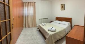 a bedroom with a bed with a dresser and a door at Casa Paradiso in Palazzo Adriano