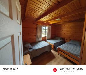 Postel nebo postele na pokoji v ubytování HelChiloé Cabañas