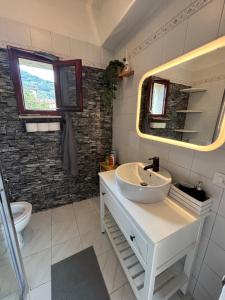 a bathroom with a sink and a mirror at La casetta di Tato in Monterosso al Mare