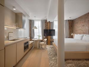 a hotel room with a bed and a kitchen at CORNER - Luxury Serviced Apartments in Montréal