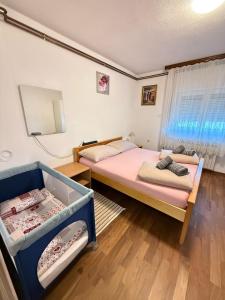 Postel nebo postele na pokoji v ubytování Apartments Marija