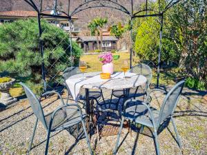 a table with chairs and wine glasses on it at Piccola Casa in Cannobio