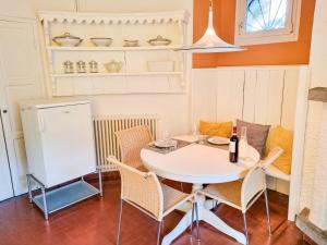 a kitchen with a table and chairs and a refrigerator at Piccola Casa in Cannobio +24 photos