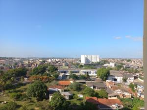 a view of a city with houses and a tall building at Condomínio Reserva da Colina in Salvador