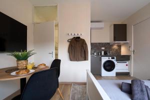 a small kitchen with a table and a microwave at Cozy & Fully Equipped Studio in Eindhoven 2 in Eindhoven