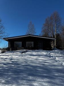 a house with snow in front of it at Harju-Hill Villa in Rovaniemi