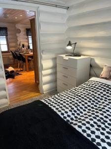 a bedroom with a bed and a desk with a lamp at Harju-Hill Villa in Rovaniemi