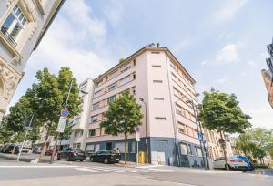 a tall white building on a city street at Stylish Studio in the Heart of Luxembourg City in Luxembourg