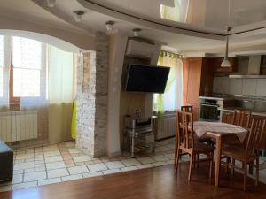 a kitchen and dining room with a table and a tv at Apartaments Teris in Zhytomyr