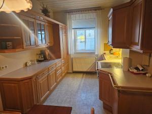 a kitchen with wooden cabinets and a sink and a window at Unterkunft für Familien, Montagen arbeiter, und und und, Sweet Home in Roßwein
